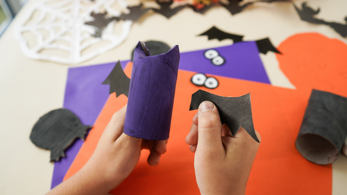 child making monster mobile with google eyes.