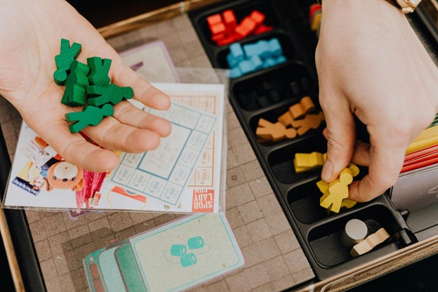 Young child sorts and matches small wooden figures.